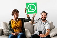 Couple showing a WhatsApp Messenger icon