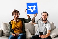 People holding up a Dropbox icon