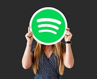 Woman holding up a Spotify icon isolated