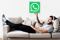Man showing a WhatsApp Messenger icon