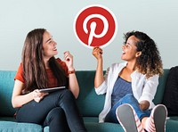 Young women showing a Pinterest icon