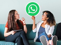 Young women showing a WhatsApp Messenger icon