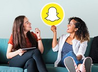 Young women showing a Snapchat icon