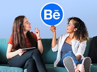 Women holding the Behance logo