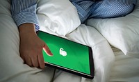 A person using Evernote in bed. BANGKOK, THAILAND, 1 NOV 2018.