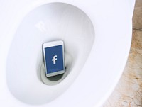 Facebook application showing on a phone in a toilet bowl. BANGKOK, THAILAND, 1 NOV 2018.