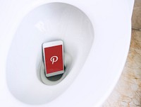 Pinterest logo showing on a phone placed in a toilet bowl. BANGKOK, THAILAND, 1 NOV 2018.
