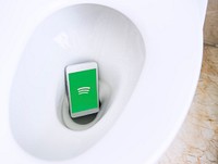 Spotify logo showing on a phone in a toilet bowl. BANGKOK, THAILAND, 1 NOV 2018.