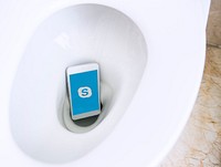 Skypelogo showing on a phone in a toilet bowl. BANGKOK, THAILAND, 1 NOV 2018.