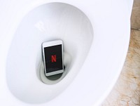 Netflix logo showing on a phone in a toilet bowl. BANGKOK, THAILAND, 1 NOV 2018.