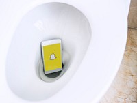 Snapchat logo showing on a phone in a toilet bowl. BANGKOK, THAILAND, 1 NOV 2018.