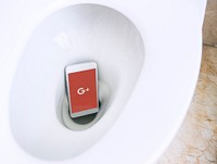 Google Plus logo showing on a phone placed in a toilet bowl. BANGKOK, THAILAND, 1 NOV 2018.