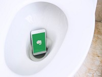 Evernote logo showing on a phone placed in a toilet bowl. BANGKOK, THAILAND, 1 NOV 2018.