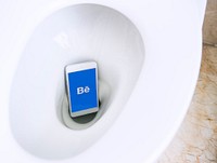Behance logo showing on a phone placed in a toilet bowl. BANGKOK, THAILAND, 1 NOV 2018.