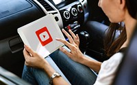 Woman sitting in a car playing Youtube application. BANGKOK, THAILAND, 1 NOV 2018.