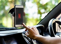 Person watching Netflix on a phone in a car. BANGKOK, THAILAND, 1 NOV 2018.