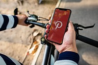 Man using Pinterest application on a bicycle. BANGKOK, THAILAND, 1 NOV 2018.