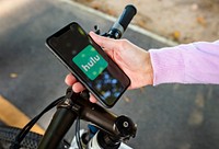 Cyclist listening to Hulu on a phone. BANGKOK, THAILAND, 1 NOV 2018.