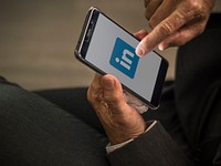 Businessman using LinkedIn application on a mobile phone. BANGKOK, THAILAND, 1 NOV 2018.