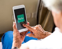 Elderly woman watching Hulu on a phone. BANGKOK, THAILAND, 1 NOV 2018.