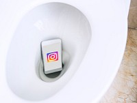 Instagram logo showing on a phone placed in a toilet bowl. BANGKOK, THAILAND, 1 NOV 2018.