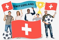 Diverse football fans holding the flag of Switzerland