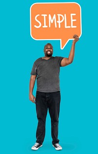 Cheerful man showing the word simple in a speech bubble