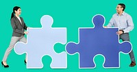 Business people connecting jigsaw puzzle pieces