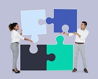 Colleagues connecting puzzle pieces