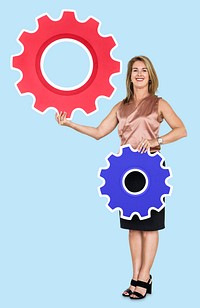 Female leader holding two gears