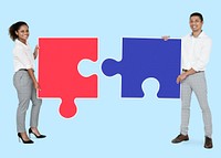 Colleagues connecting puzzle pieces