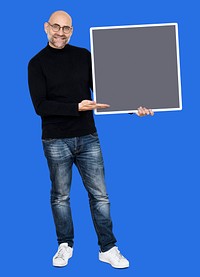 Cheerful man presenting a blank gray square board