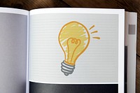 Light bulb drawing on a magazine