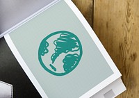 Green globe drawing on a book