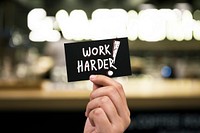 Work harder phrase written on a card