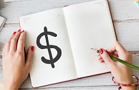 Woman drawing a dollar sign on a notebook