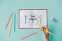 Hand writing Eat clean on a notebook