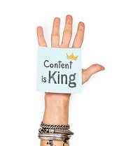 Hand showing a sticky note with Content is king