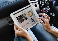 Woman using a tablet in the car