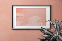 Black wooden photo frame with peach color painting on wall