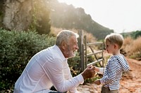 Grandfather shaking hands with his grandson, vivid tone