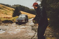 Man pulling the car towing cable, vivid tone