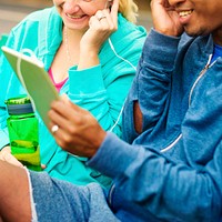 Couple listening to music from a tablet