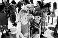 Group of diverse kids standing together grayscale