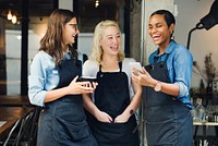 Baristas watching something funny on a phone