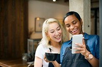 Colleagues playing on a phone at a coffee shop