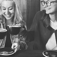 Friends having coffee in the cafe together