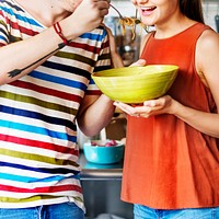 Couple sharing eating a bowl of spaghetti