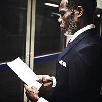 Business man reading while in commute
