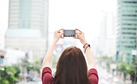Woman taking a photo with her phone